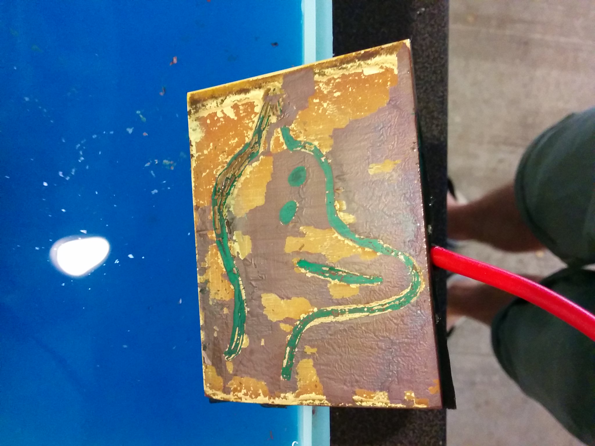 After about 20 minutes of etching at 2.5A. Note the regions where the brass is showing through the green marker mask. This prompted a rethink and the new paint mask