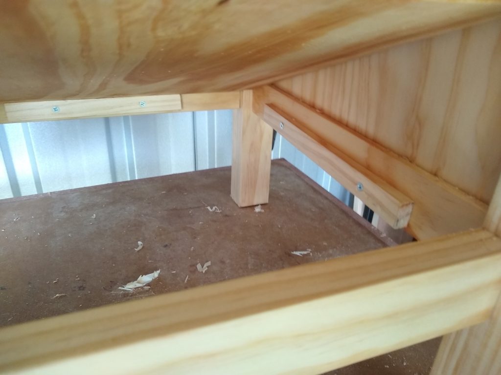 The base just sits on 4 rails underneath it on the frame. Since these will not be seen, they are just screwed in place