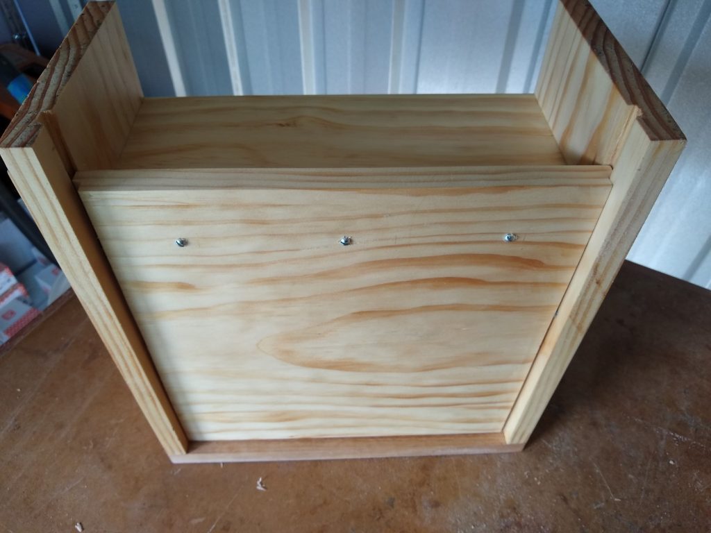 The base is not glued and only attached with 3 screws at the back, with elongated holes to allow for wood movement.